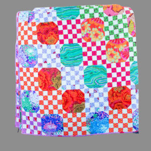 Quilt featuring fabric designs from Kaffe Fassett ’55